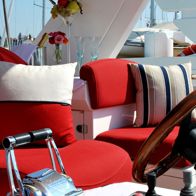 Customised red yacht upholstery for helm seats in exterior of - Sealine T-60 decorated with Frey Luxury Pillows.