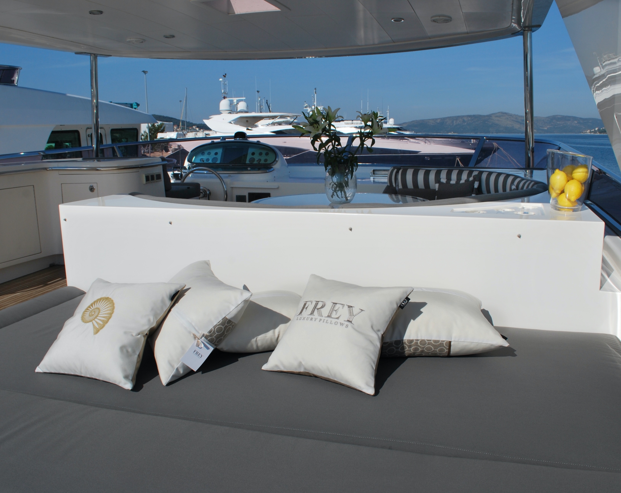 Frey soft Luxury Pillows scattered on newly reupholstered grey sun lounge cushions on the flybridge of Horizon Elegance 78ft.