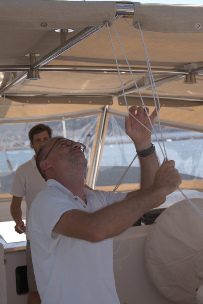 On the S/Y Perini Navi Burrasca, Ante from Frey, strengthens new beige, flybridge sprayhood over steel frames with white rope.