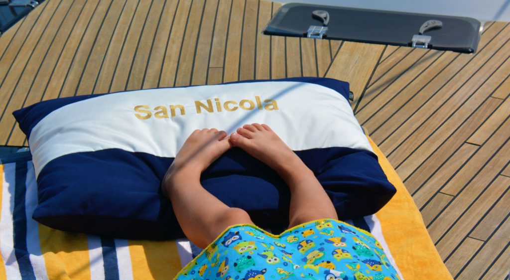 Soft Frey Luxury Pillows with embroidered Bavaria yacht name San Nicola, is perfect for a kids nap after sailing or swimming.