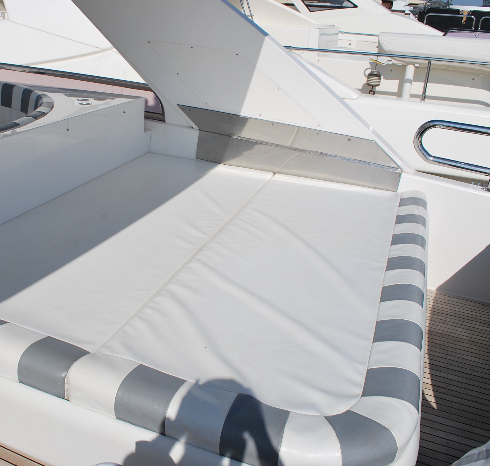 Elegance 78ft yacht bow sunbed before photo, with dominating white colour and striped edging, needs new life and new style.