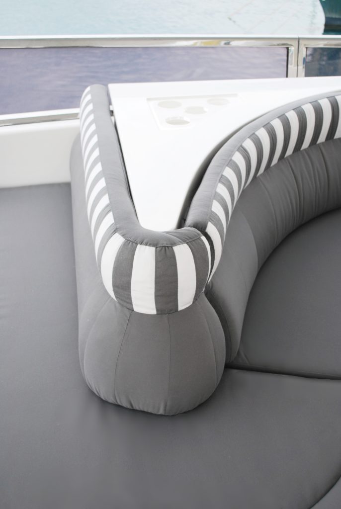 Continuous flow of grey and white stripes on backrest of the curviest of corners of seating on flybridge zone.