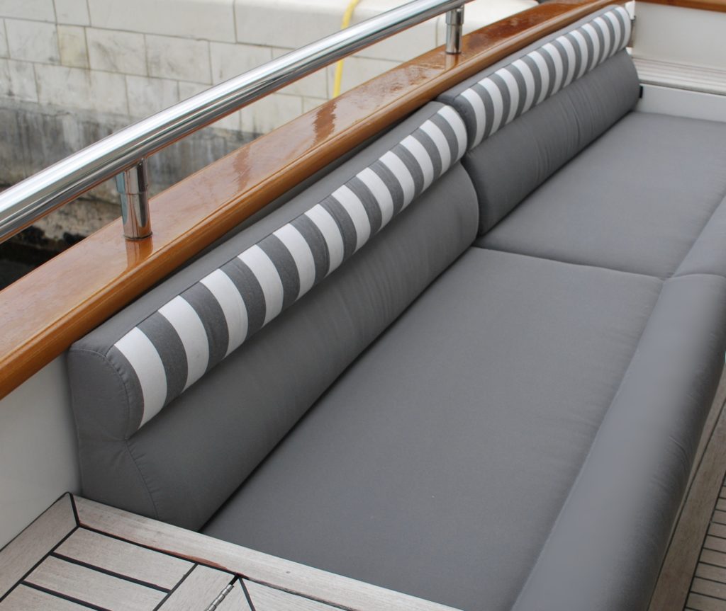 Luxurious Elegance 78ft yacht comfy refit cushions for exterior seating in grey & white timeless stripes offset wood finishes.