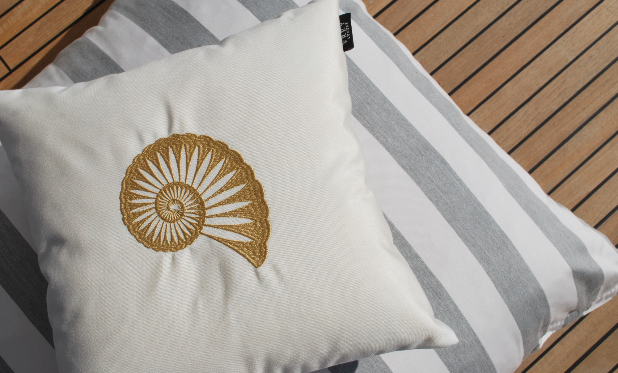 Soft, comfortable white & striped Frey Luxury Pillows with gold embroidered shell for Horizon Elegance 78ft yachts' cushions.