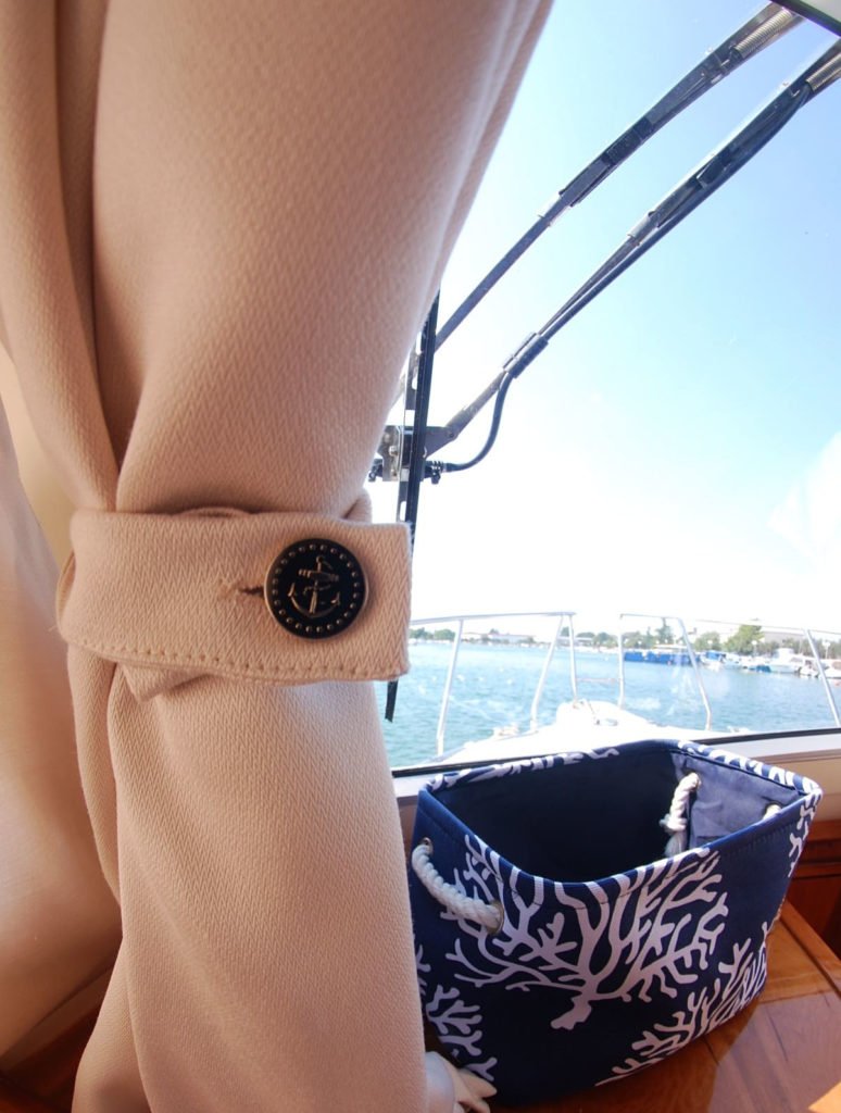 Stylish, ivory curtains, handcrafted with a nautical button detail, instantly updates and adds class to your yacht interior. 