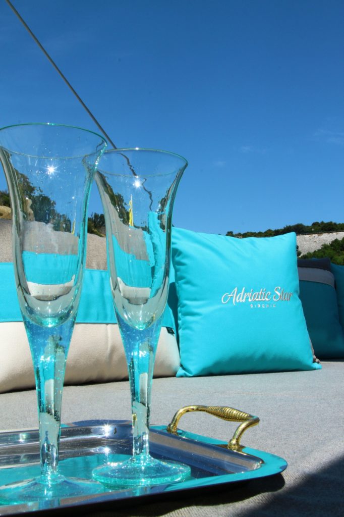 Drinks served on Lagoon 52 F catamarans new reupholstered cushions for flybridge with personalised turquoise luxury pillows. 