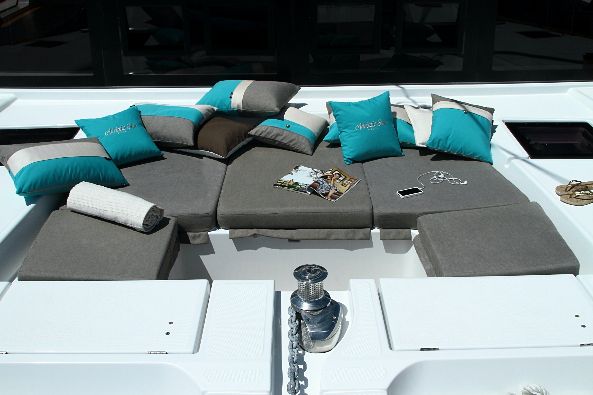 Complete new upholstery cushions in U-shaped seating area in Lagoon 52 F forward cockpit, with soft pillows for chill zone.