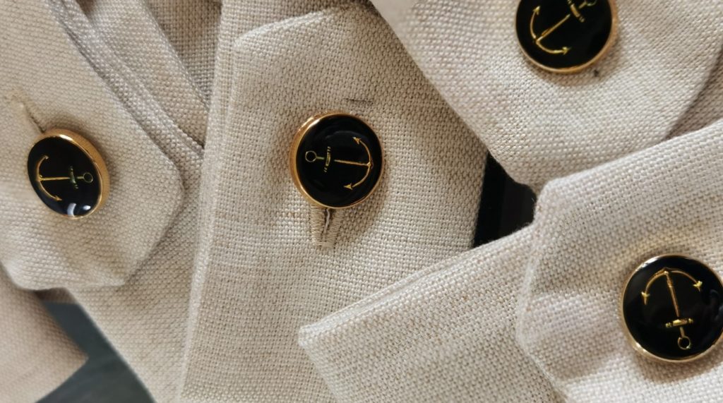 Personalised yacht curtain holders with unique gold or silver nautical buttons to authentically stylise your yacht upholstery.