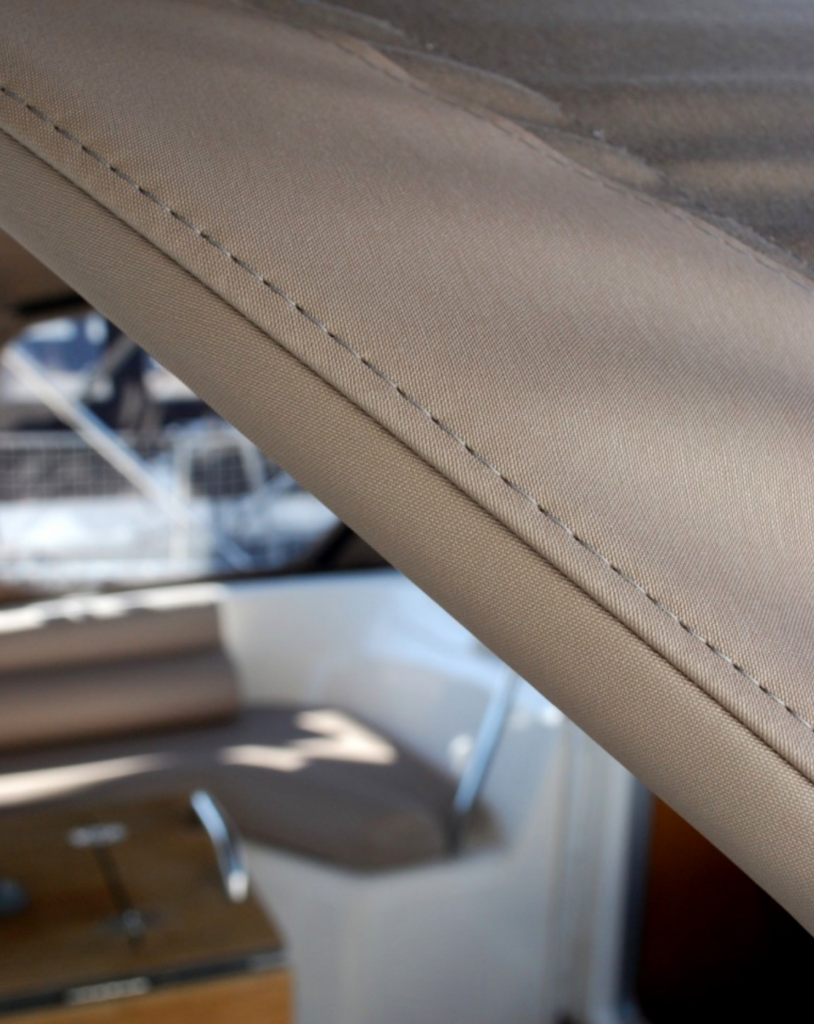 Detail stitching of new stone colour bimini top in durable, high UV protection, Sunbrella Plus marine fabric for Bavaria 55.