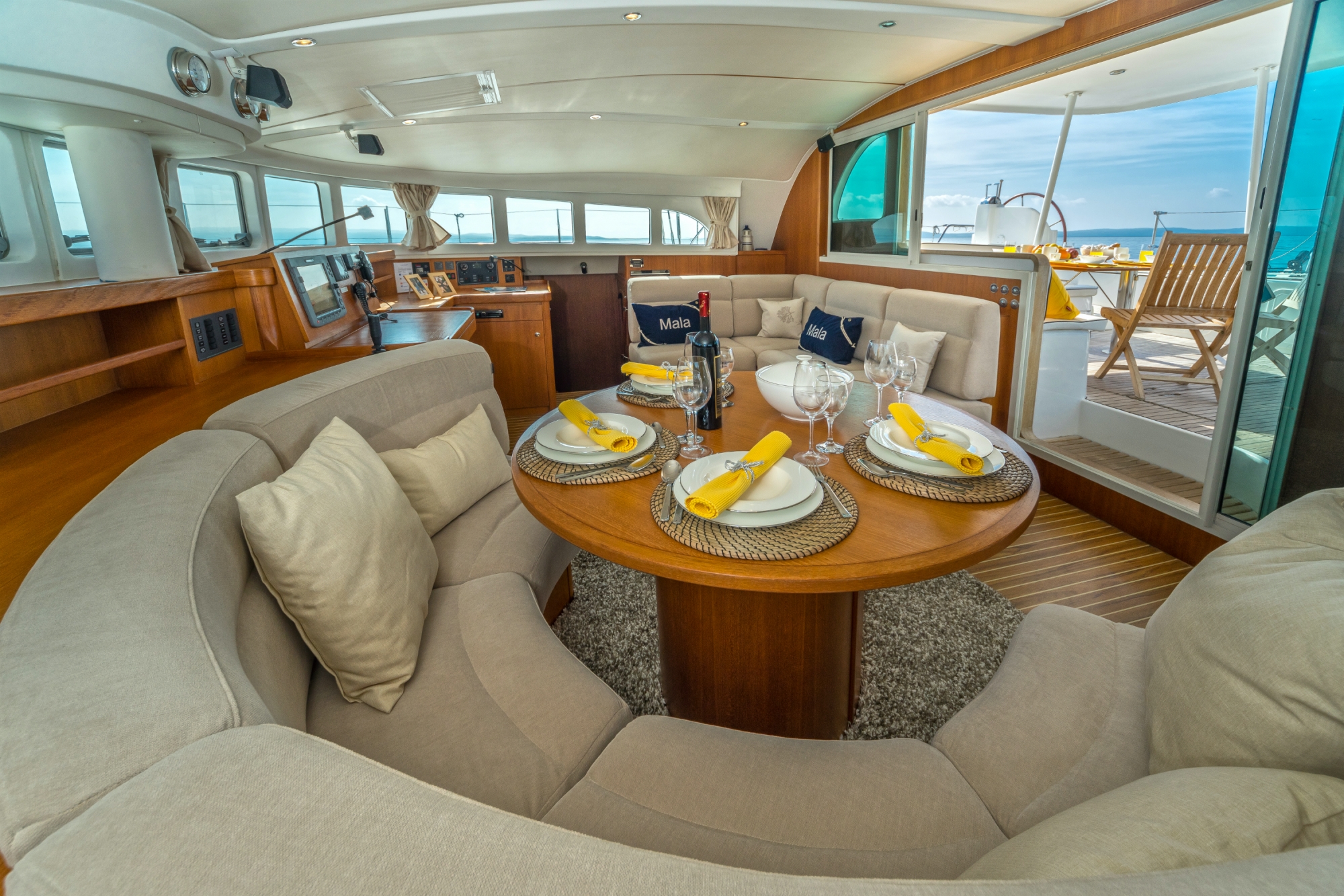 Reupholstery yacht interior cushions by Frey for Lagoon 570 Mala, in Aqualclean beige & co-ordinating personalised pillows.
