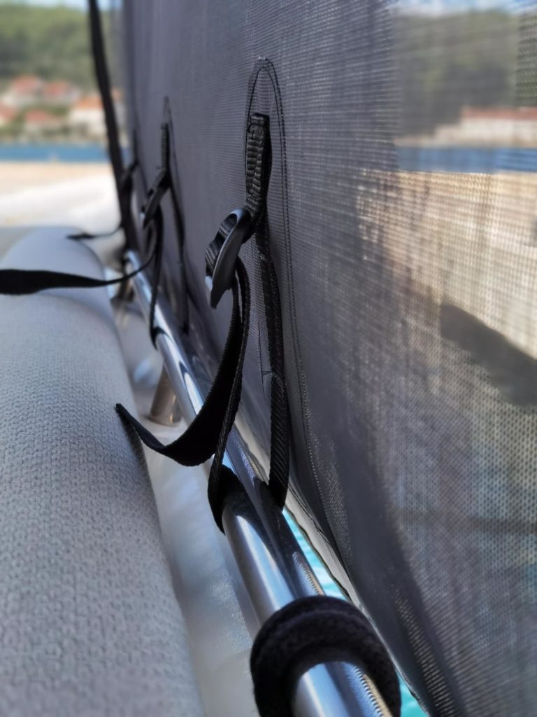 Black cockpit sunshades, secured to steel rail with strong black straps & buckles for extra strength on Prestige 460S yacht.