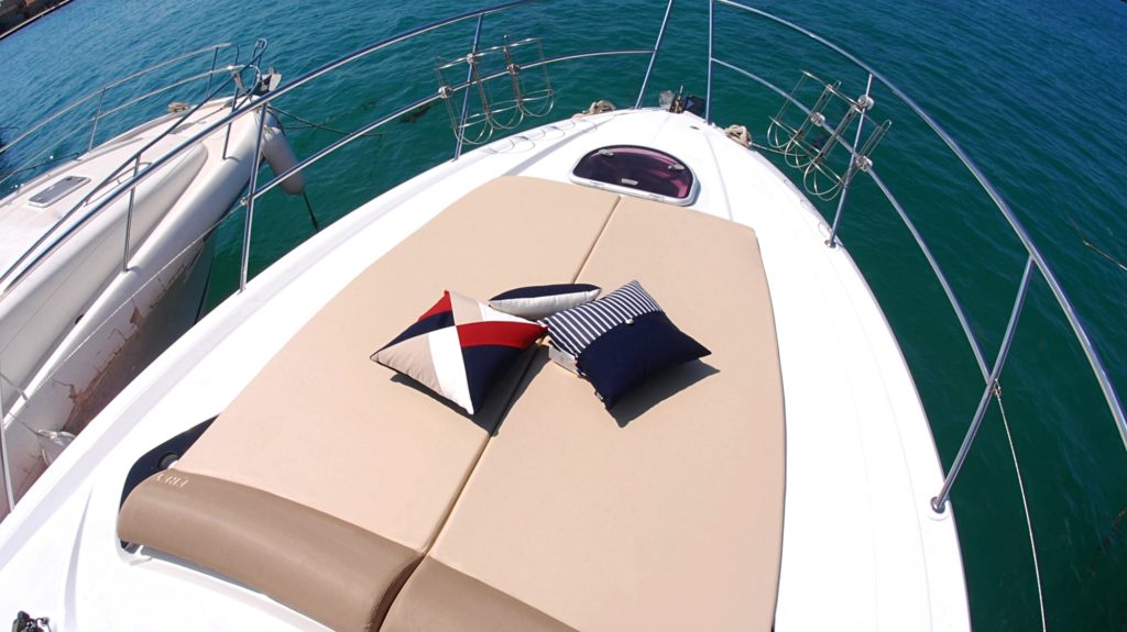 Beige coloured yacht sunbed cushions are a perfect backdrop for authentic, nautical Frey Luxury Pillows.