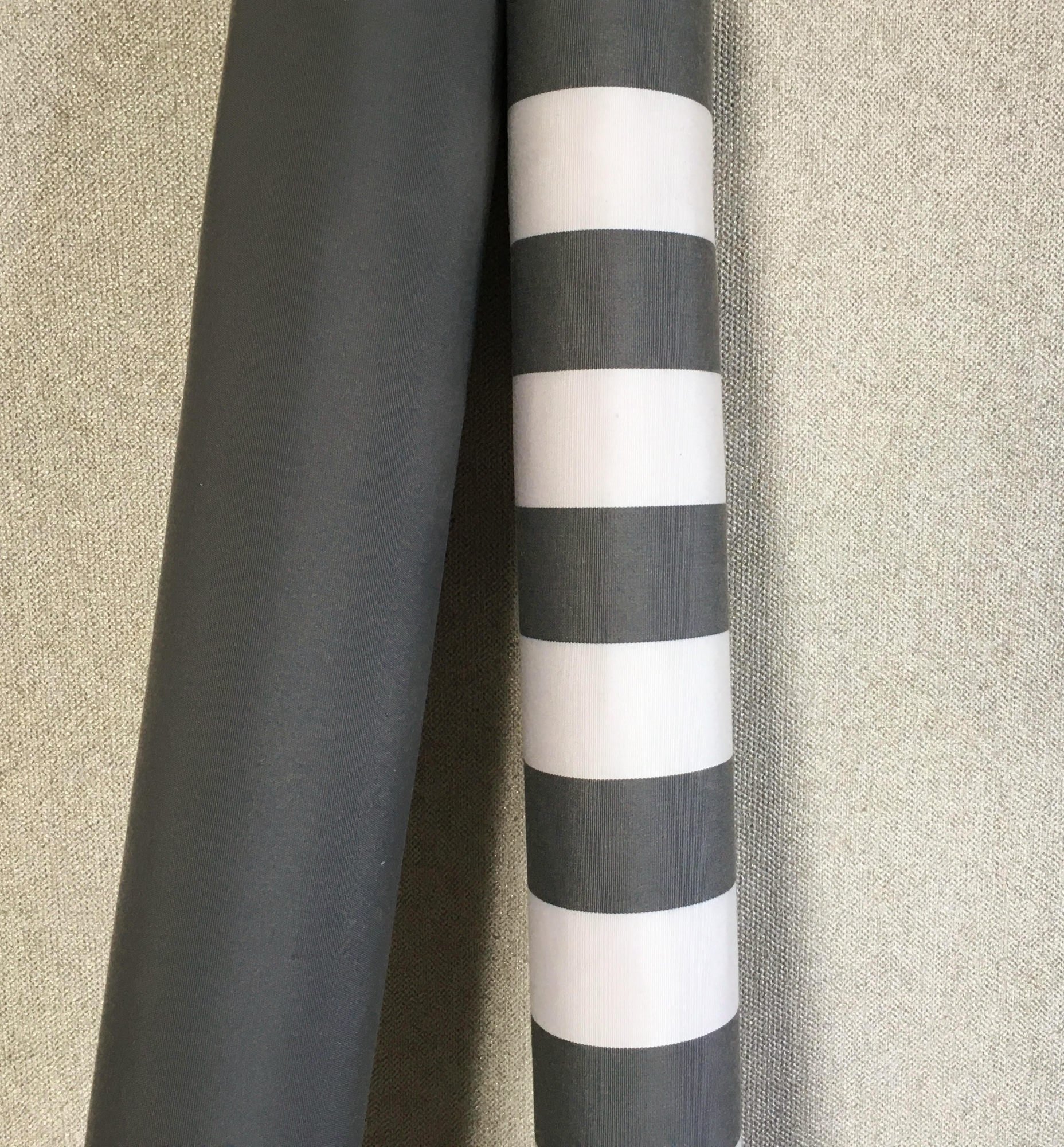 Yacht stripes in grey & white with complimenting charcoal grey from Sunbrella Cushions® for durable yacht exterior cushions.