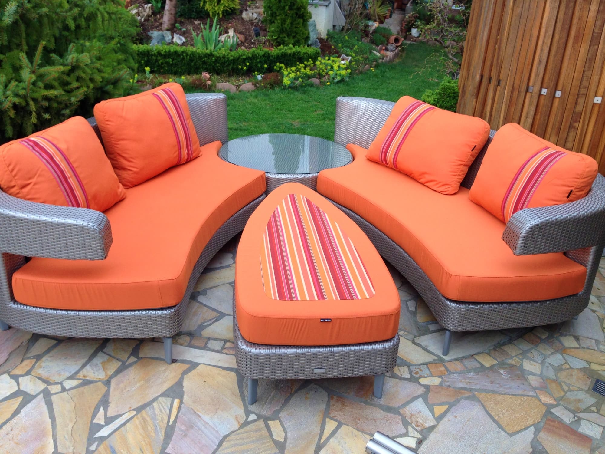 Premium reupholstered garden furniture cushions in orange stripe, dry fast, are fadeproof and can  be left in sun or rain. 