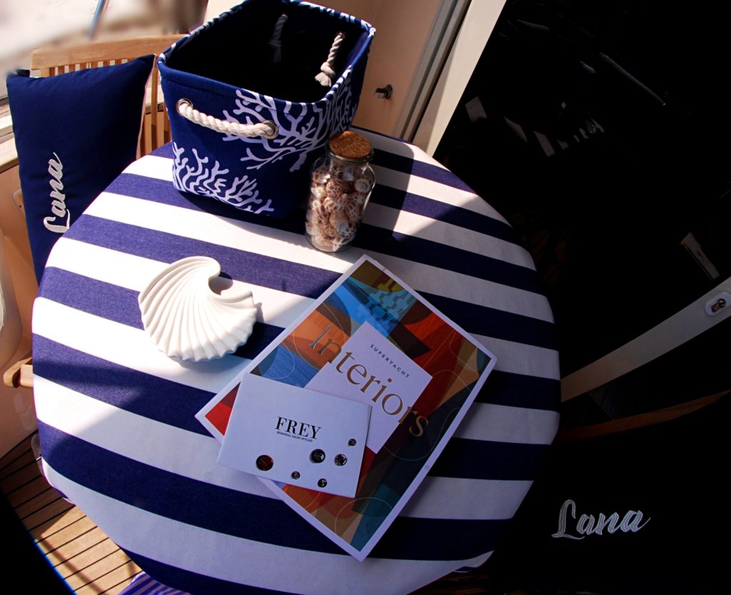 Gorgeous blue & white striped nautical tablecloths match elegant peronalised Frey Luxury Pillows for exterior yacht refit.
