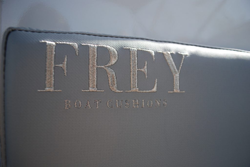 Embroidered Frey logo on quality handcrafted boat cockpit cushions on Tornado 38 motor boat. Grey marine fabric by Italvipla. 