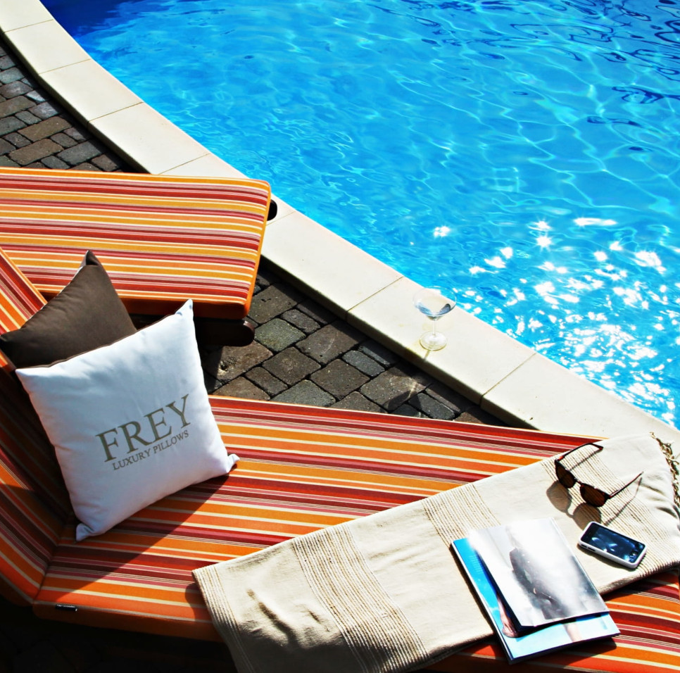 Comfy orange, red, pink stripe water-repellant poolside deck chair cushions with dryfast sponge & Frey Luxury Pillow decor.