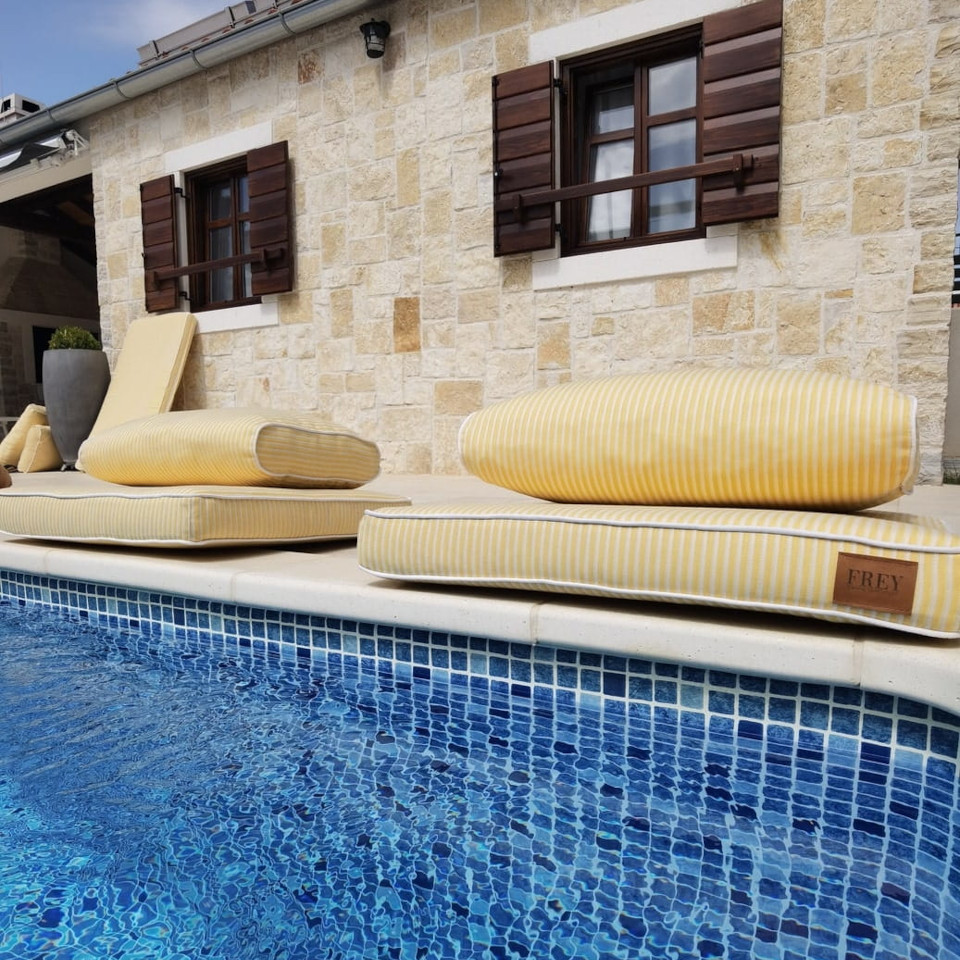 Irresistable yellow outdoor poolside cushions in UV Pro fabric for Villa Stella guest house. Comfortable & water-repellant.