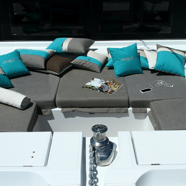 Luxurious Elegance 78ft yacht comfy refit cushions for exterior seating in grey & white timeless stripes offset wood finishes.