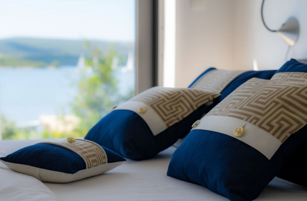 Frey Luxury Pillows, Midnight Sailing collection in bedroom of Villa Lu-Ma, with view of heart shaped island of Galešnjak.