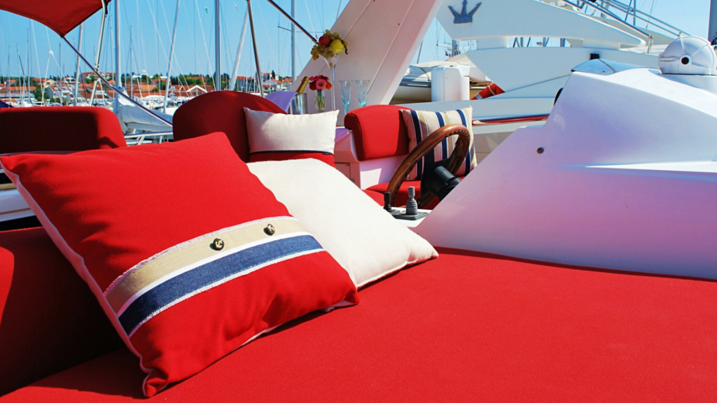 Sealine T-60 luxurious,and elegant sunbed cushions in a bold red colour beautifully compliment the white yacht.