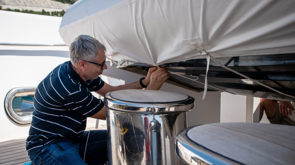 Frey team securing premium protection awnings, with strong straps and stainless steel buckles for Nautique, megayacht tender.