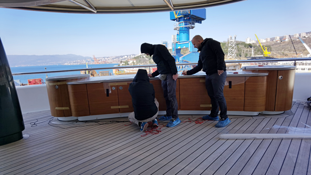 Team Frey taking precise measurements for deck bar premium protection covers on aft area of megayacht Kusch.
