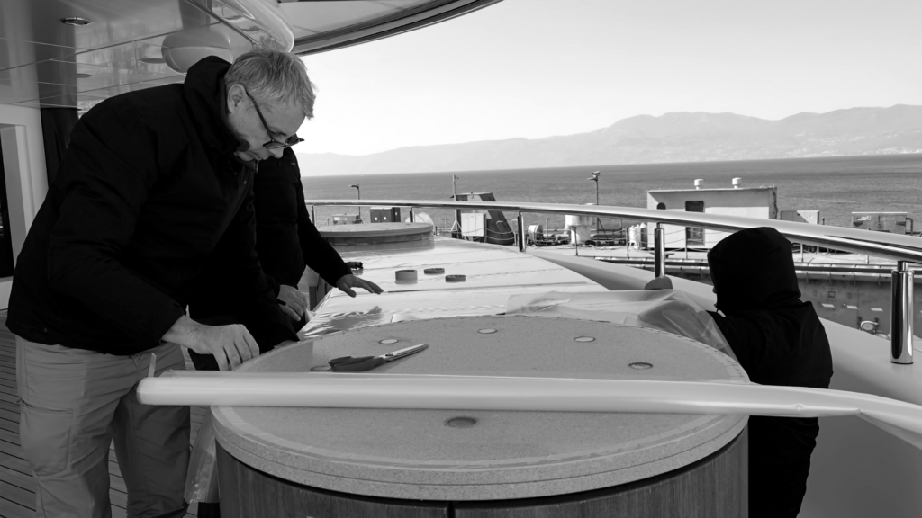 Frey Personal Yacht Stylist team taking precise measurements for premium protective covers for deck bars on superyacht Kusch.