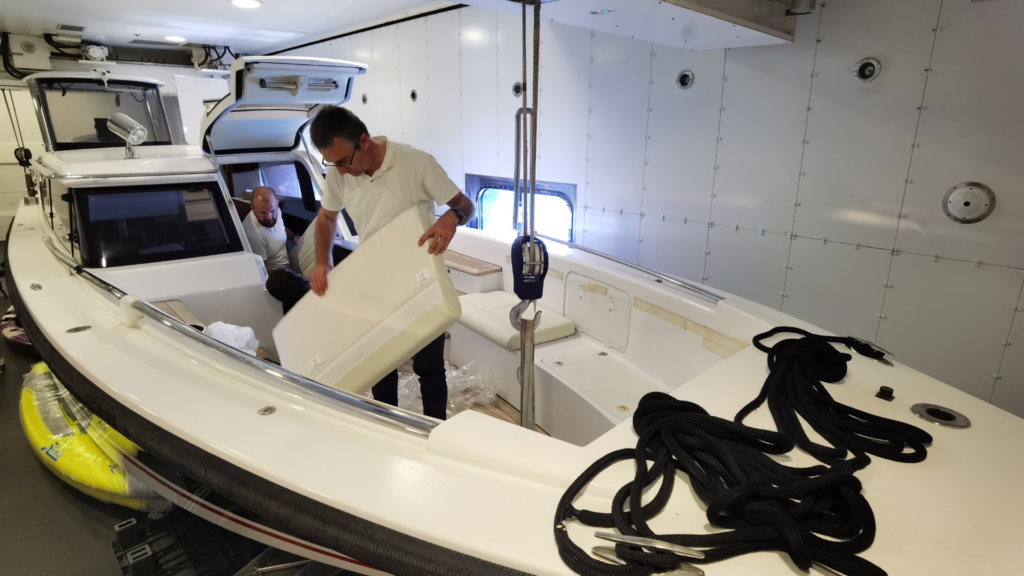 Team Frey installing newly reupholstered cushions on forward deck of Al Mirqab superyacht tender Vikal Limousine 12m.
