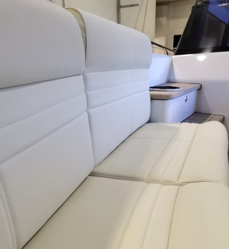 Custom exterior seating in aft and forward cockpit reupholstered in premium Spradling vinyl beautifully accompanies interior.